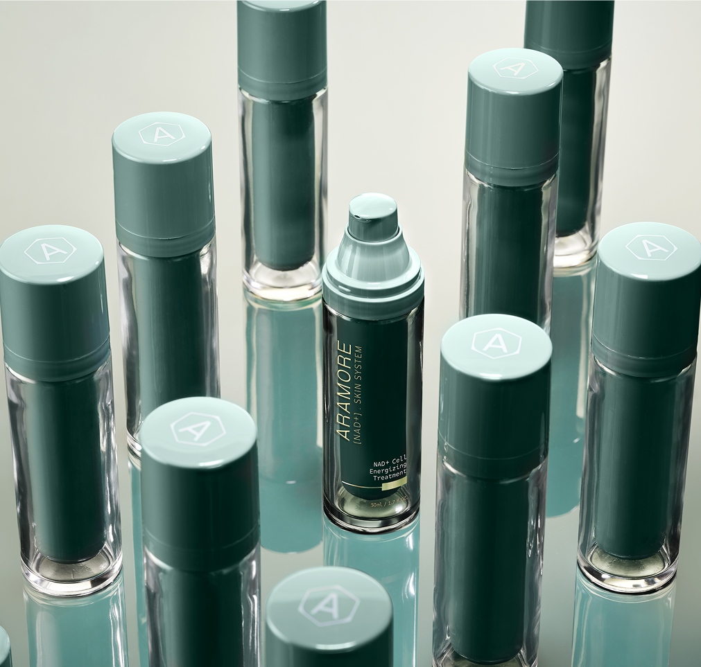 Many 30 ml Aramore NAD+ Cell energizing treatment bottles on a mirrored surface