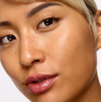 Close-up of a person with short blonde hair and neutral background