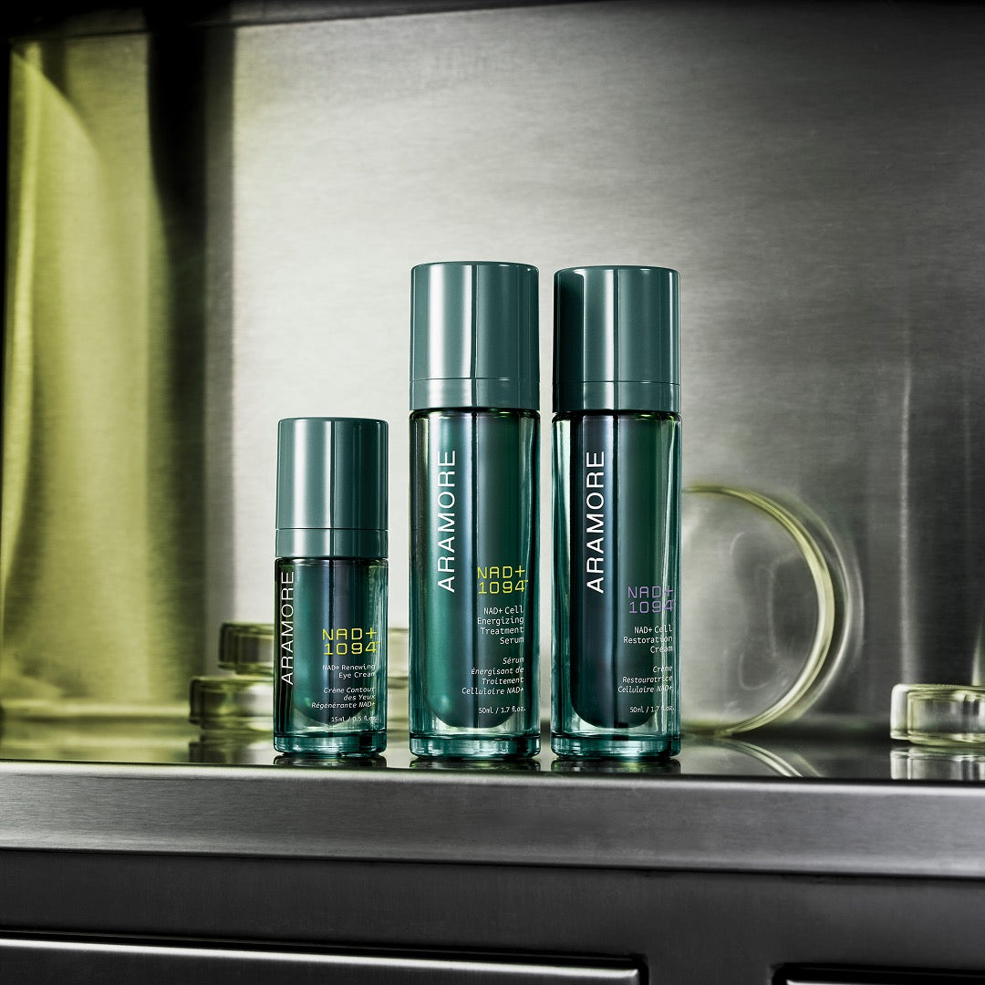 NAD+ Trio of Restoration Cream, Energizing Treatment and Eye Cream on metallic shelf with lab glass in background