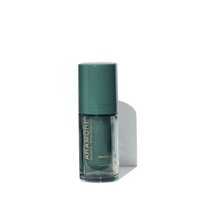 A green bottle of facial serum with a matching cap.