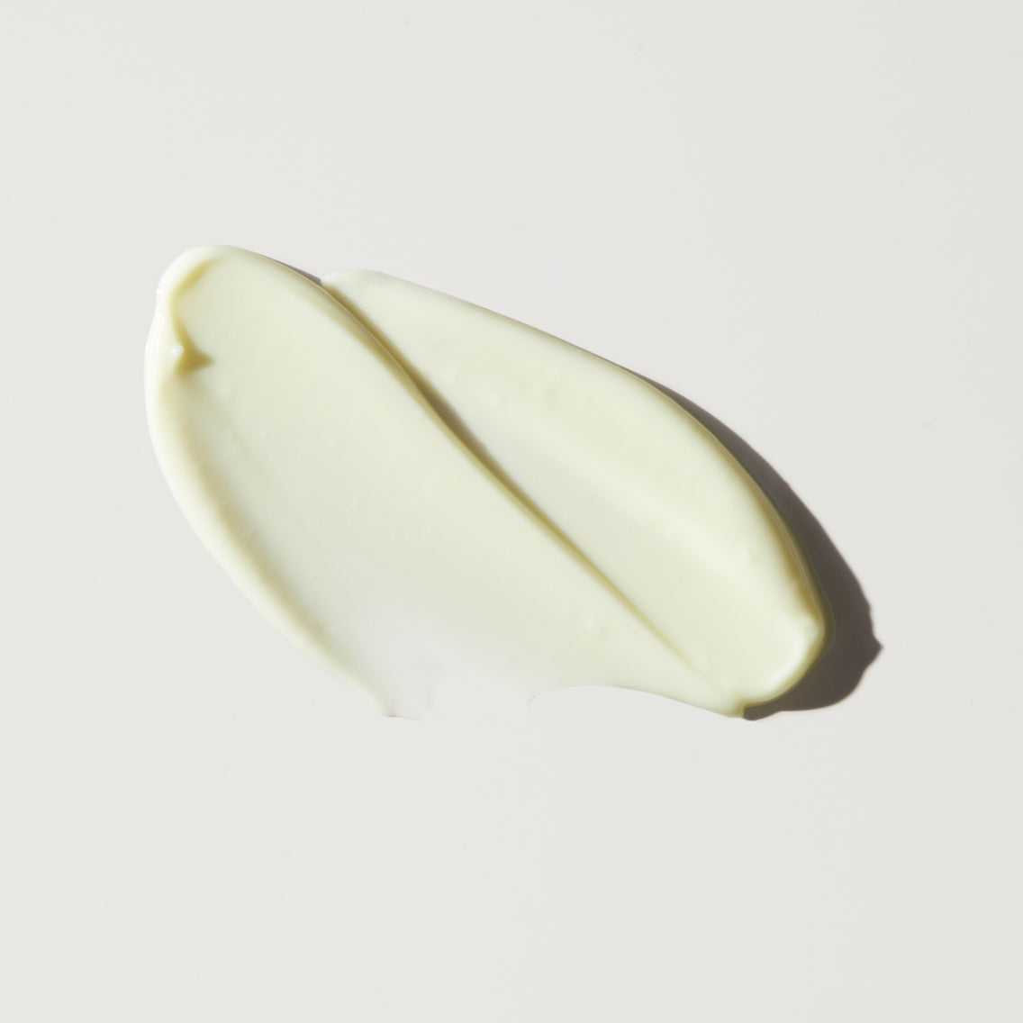 A smooth, creamy white substance spread on a flat surface.